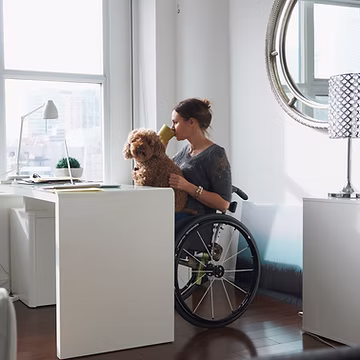 Woman in wheelchair drinking coffee